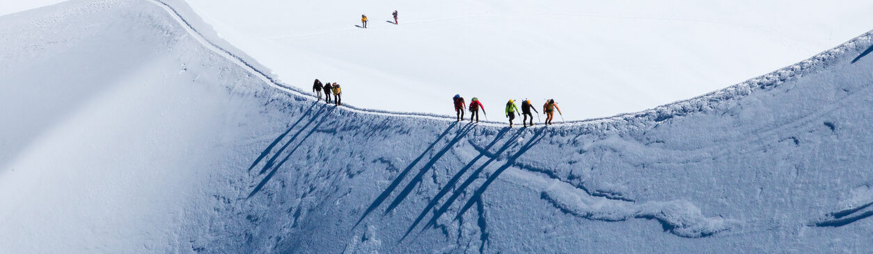 Skiers walking the ridge at the aiguille du midi Chamonix