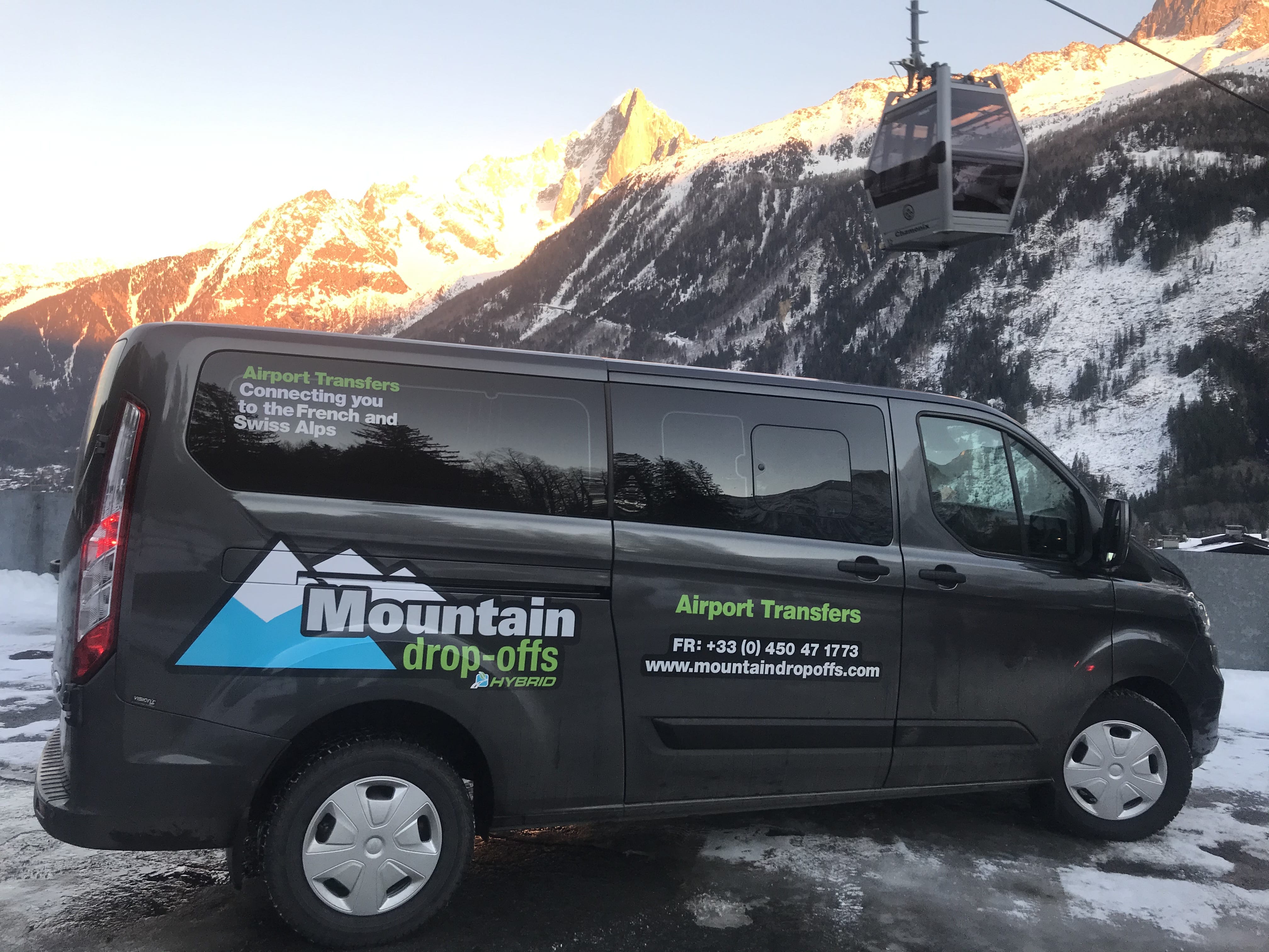 Chamonix transfer hybrid transfer vehicle in front of mountains